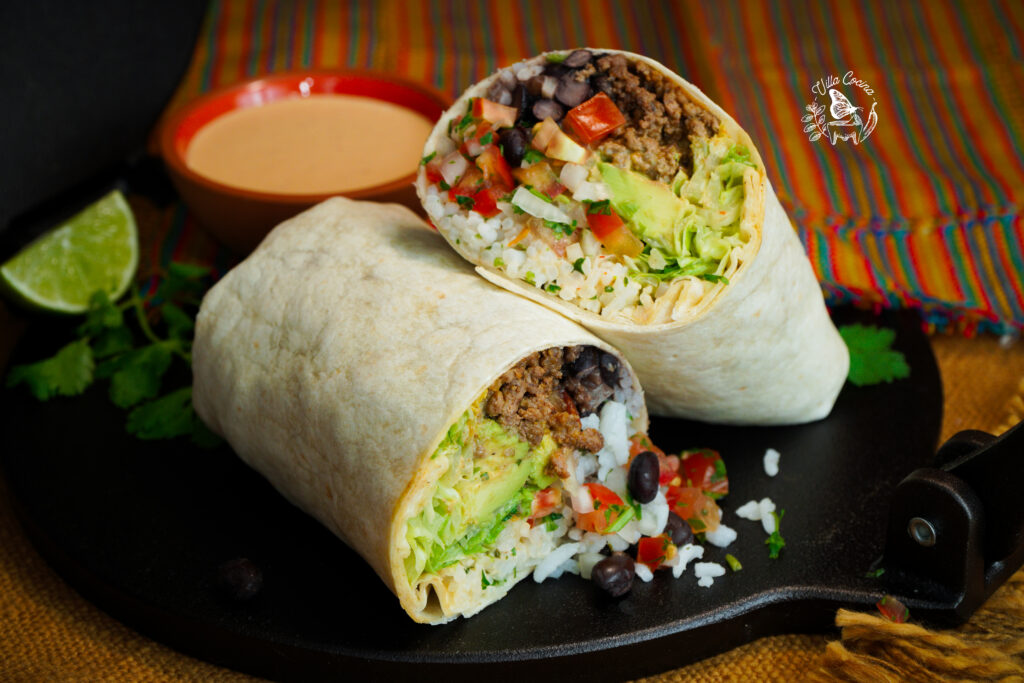 A burrito being wrapped at the counter