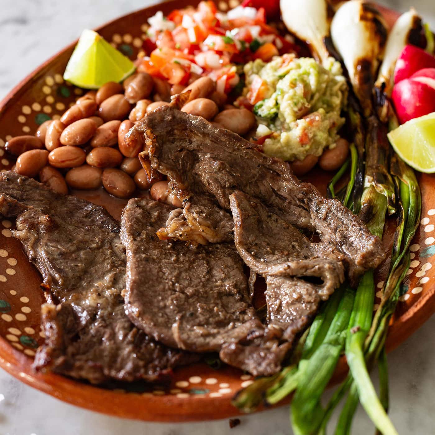 Char-grilled carne asada platter with rice, beans and warm tortillas